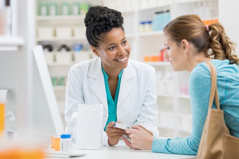 Pharmacist consults with female patient